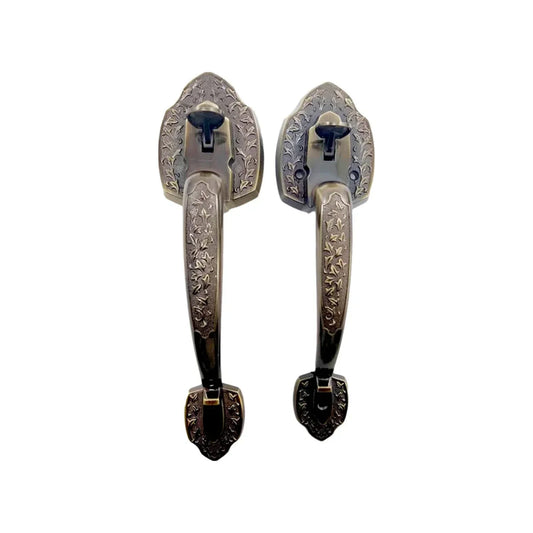 Par de jaladeras de puerta principal cobre antiguo, con grabado floral y bases decorativas estilo vintage.