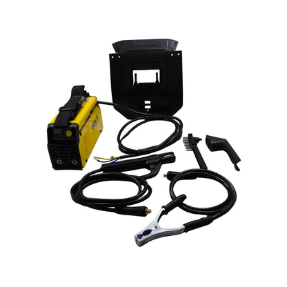 Soldadora Inverter Volt Pro 140A amarilla con careta, cables, pinzas y cepillo de alambre para trabajos de soldadura.
